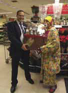 Waitrose Deputy Manager, Jeremy Barnard, presents Rico the Clown (Whyteleafe resident and circus clown, Ricardo Leon) with his prize of a Waitrose Christmas hamper.