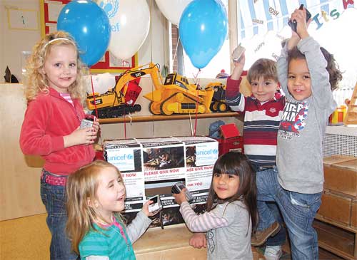 Children from Asquith Nursery with some mobile phones for their collection box.