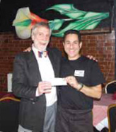 Aldo Floris (right) presenting the cheque for £660 to Dick Moran.