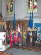 The guides and brownies with their standards in St. Mary's Church.