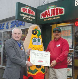 Past chairman of Tandridge District Council and Honorary Alderman, Terry Servant presents the ‘Pizza Delivery Chain of the Year’ certificate to the manager of Papa John's in Caterham, Danny Saadany.