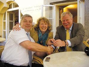 Carolle Thompson (centre) and her husband Roger (right) on a visit to Prague last year, symbolically exchanging intellectual property (on a memory stick) with Dr Martin Stolin, of STAR Learning s.r.o.