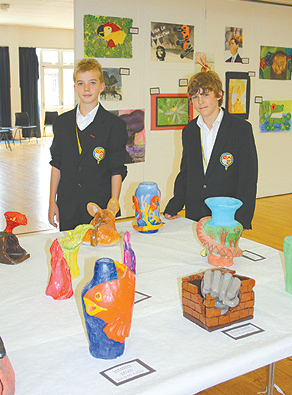 de Stafford year 8 tour guides, Jack Gillam (left) and George Azzopardi with some of the artwork on display in the main hall during ‘Ubuntu Day’. Photograph by Emma Berry