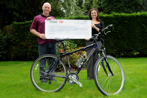 Cllr Pat Cannon presents St Catherine’s Hospice Community Fundraiser Victoria Lawrence with the cheque following his cycling challenge. 