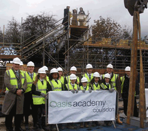 Rev Steve Chalke, founder of Oasis, David Millar Principal of Oasis Academy and students watch the time capsule being buried.