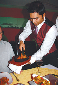 Our waiter serves up the sizzling Anarashi Hash, straight from the clay oven.