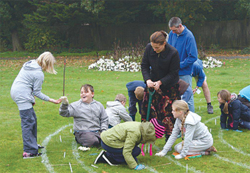 Hillcroft School pupils planting crocus bulbs in Queen's Park.