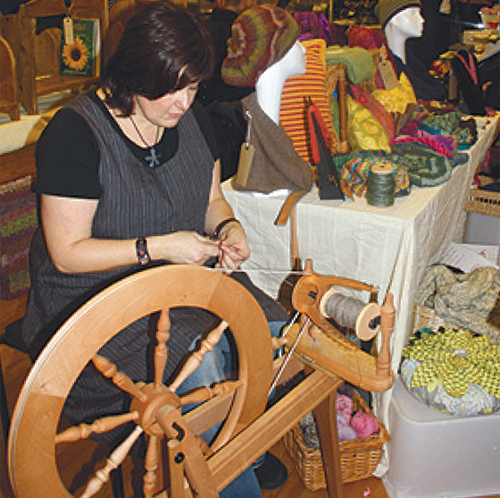 Sarah Goodwin of The Yarn House at her spinning wheel.