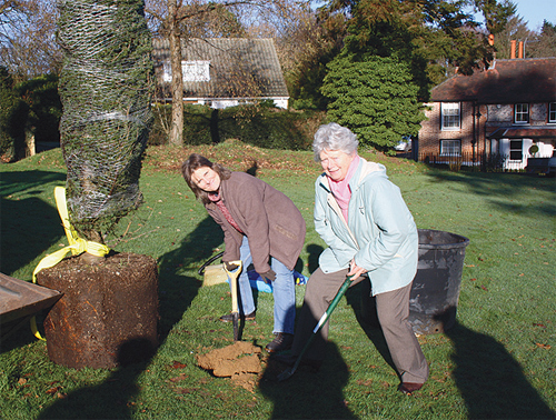 Parish Councillors Sarah Burningham (left) and Mary Mountain preparing for the tree planting on Salmon's Lane Green