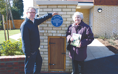 Jeremy Webster and Jean Tooke by a plaque marking Caterham Court, demolished for redevelopment of Stanstead Road in 1926.