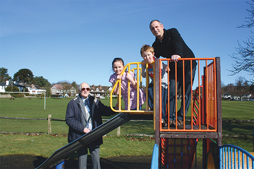 Tandridge Community fund Chairman, Mike Moss (left) with Paul, Phoebe and Joseph Marks of the Godstone at Play group on the play equipment due to be replaced this summer. 