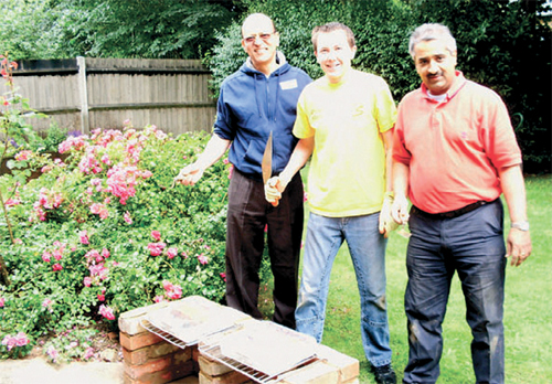 Volunteers with the new barbecue in the garden of Diana Francis House.