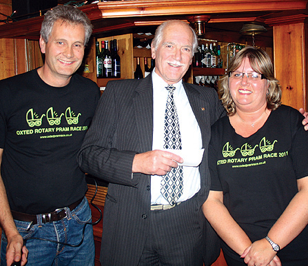 Pram Race Committee members Richard Knight and Libby Nicholls with the chairman of the Tandridge Community Fund, Mike Moss at the presentation evening.