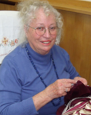 A lady from the Miller Centre Costume Department working on Mrs Cheveley's dress.