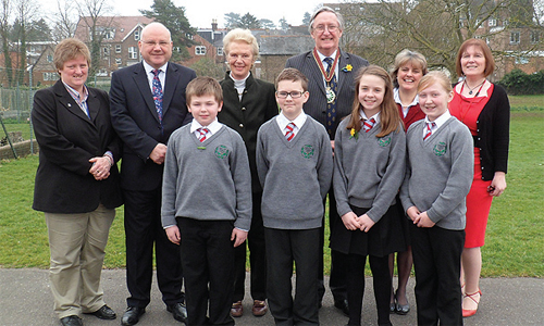 From left: Wendy Parr, Cllr. Chris Botten, Lady Corinna Hamilton, The High Sheriff of Surrey, Prof. Michael Joy OBE, Lady Louise O’Connor and Headteacher Stephanie Scutter with Year 6 pupils from Hillcroft School.