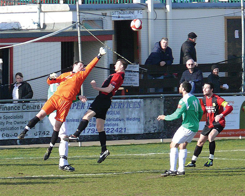 Leafe keeper Paul Smith punches clear.