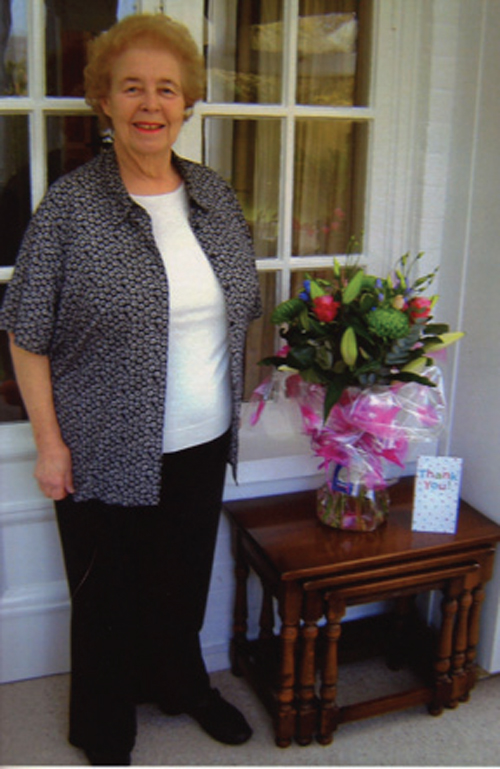 Pamela Windsor with the flower arrangement she received as a token of thanks for her long service to Caterham businesses.