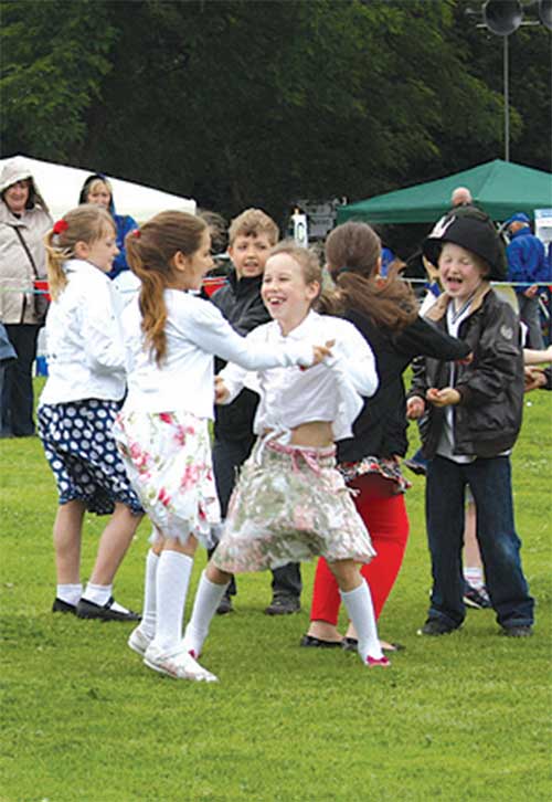 Children from Bradmore Green Primary School dance for the crowd.