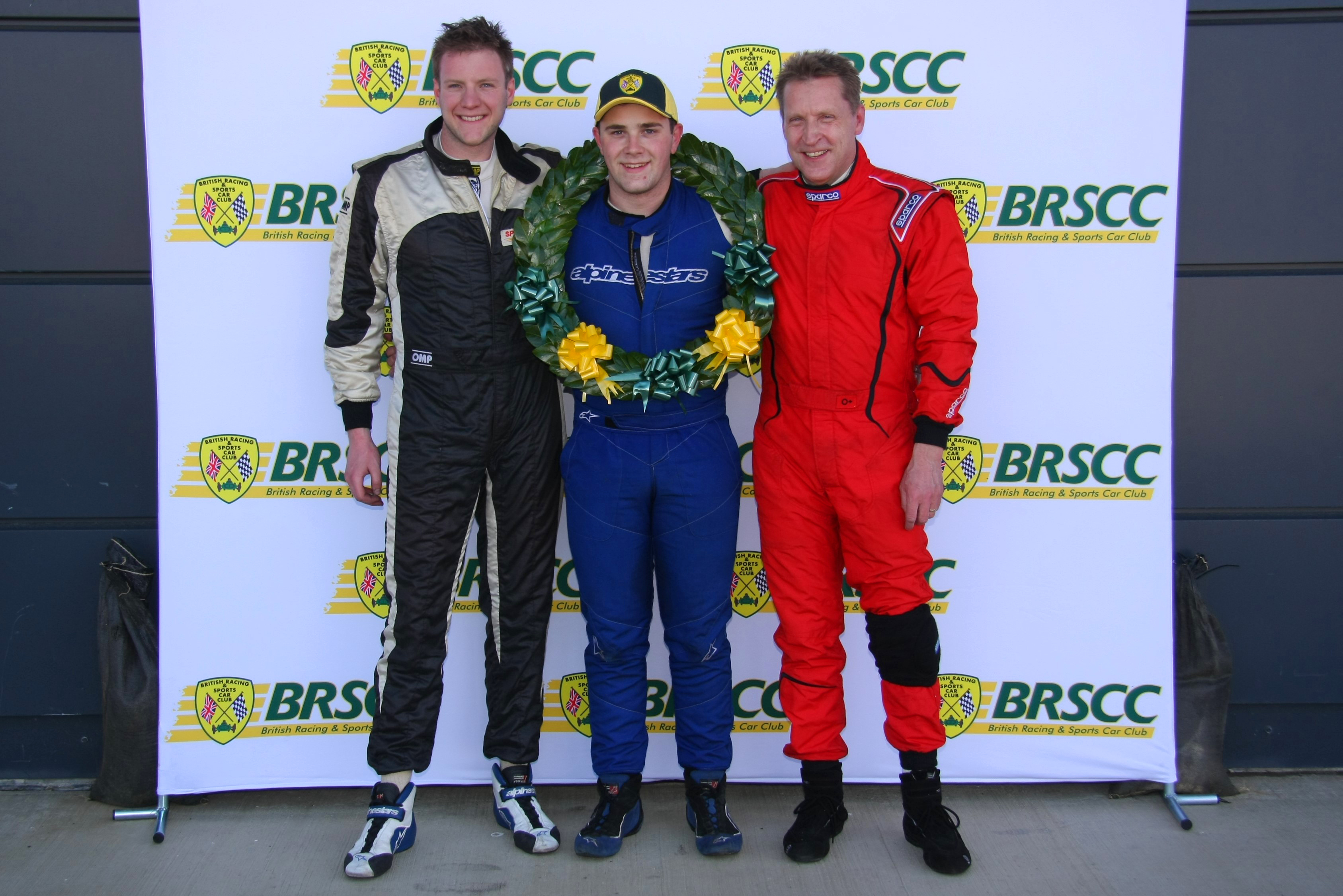 Michael Gibbins on the podium after winning race 1, flanked by Tom Stoten who came second (left) and Nick Bacon who came third. Photo by Kevin Gibson.